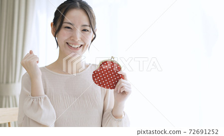 Young woman holding a purse Young woman holding a purse 72691252
