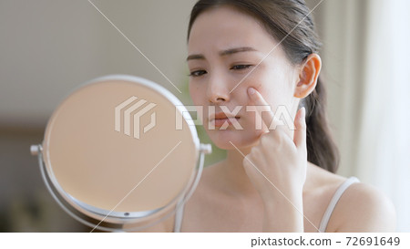 Young woman doing skin care Young woman doing skin care 72691649