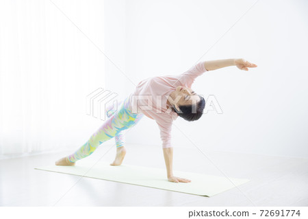A woman in her 50s doing yoga A woman in her 50s doing yoga 72691774
