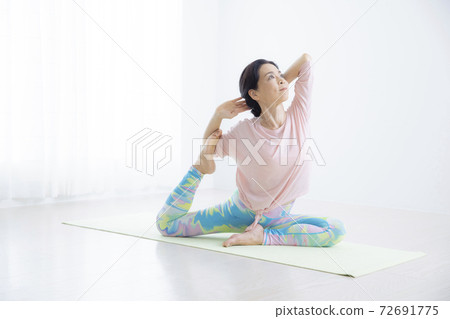 A woman in her 50s doing yoga A woman in her 50s doing yoga 72691775