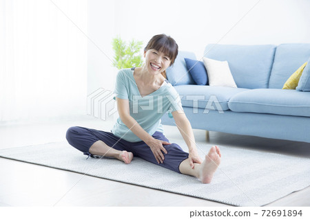 A woman in her 50s doing yoga 72691894