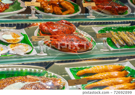 Assortment of delicious cooked food in restaurant's showcase 72692899