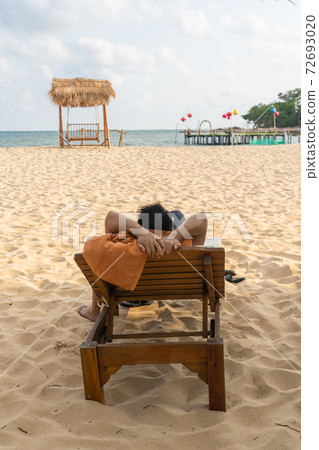 Young man resting on the beautiful beach Young man resting on the beautiful beach 72693020