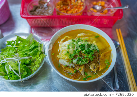 Bowl of delicious fish noodles soup served with vegetables Bowl of delicious fish noodles soup served with vegetables 72693320