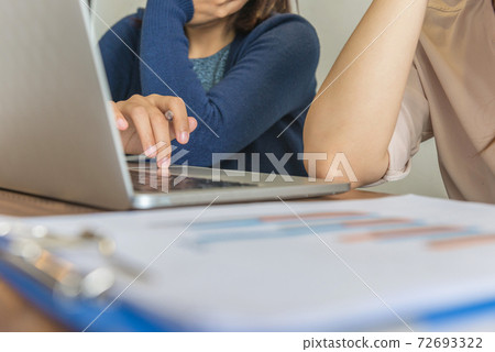 Close-up of woman hand using laptop touchpad while having discussion Close-up of woman hand using laptop touchpad while having discussion 72693322