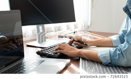 Software developer or programmer working data debugging improvement binary algorithm on desktop pc in a software develop company office. Software developer or programmer working data debugging improvement binary algorithm on desktop pc in a software develop company office. 72693523
