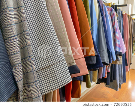Beautiful outfits hanging at women's fashion store Beautiful outfits hanging at women's fashion store 72693535
