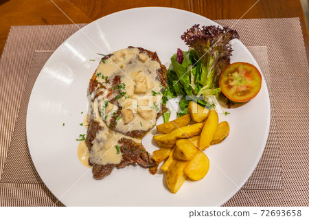 Close up photo of beef steak and creamy mushroom sauce Close up photo of beef steak and creamy mushroom sauce 72693658