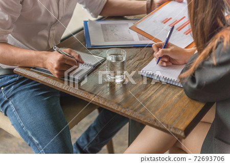 Close up of human hands writing on notebook Close up of human hands writing on notebook 72693706