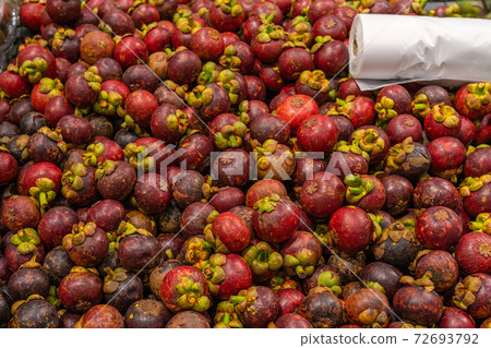 Pile of mangosteen for sale at tropical fruit 72693792