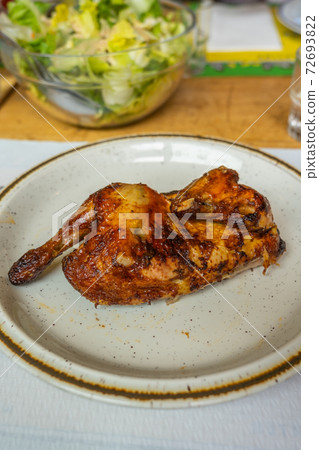 Crispy half roasted chicken on white plate in Crispy half roasted chicken on white plate in 72693822