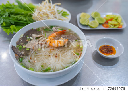 Bowl of famous Vietnamese rice noodle served with vegetables Bowl of famous Vietnamese rice noodle served with vegetables 72693976