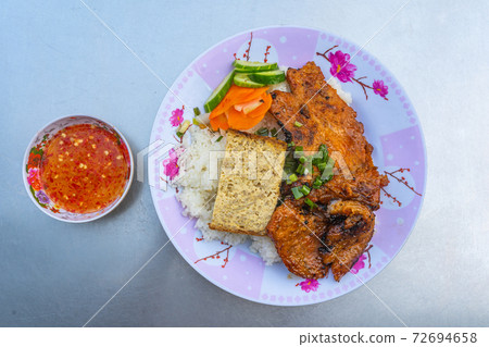 Plate of tasty Vietnamese pork chop rice on table Plate of tasty Vietnamese pork chop rice on table 72694658