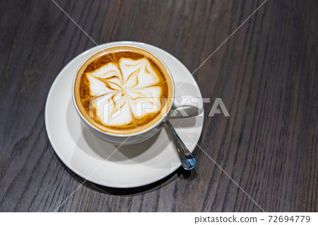 Overhead view photo of latte art milk foam cappuccino coffee  72694779