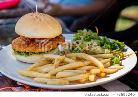 Close up of homemade cheese chicken burger and Close up of homemade cheese chicken burger and 72695240