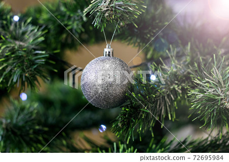Christmas ball on branch of elegant spruce 72695984