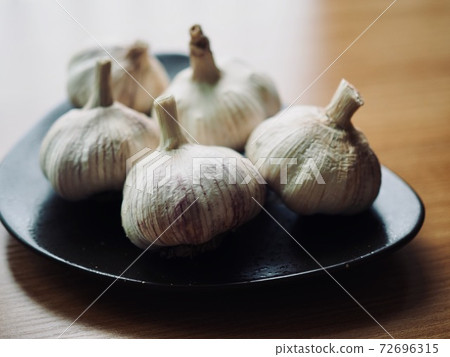 Organic Vegetable Garlic in Ceramic Plate 72696315