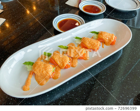Fresh asparagus and smoked salmon rolls on plate on the table. Healthy delicious eating. Fresh asparagus and smoked salmon rolls on plate on the table. Healthy delicious eating. 72696399