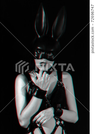 submissive girl handcuffed for BDSM sex sensually touches her finger to her lips submissive girl handcuffed for BDSM sex sensually touches her finger to her lips 72696747