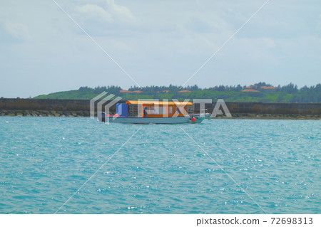 Sunny day sea and one orange boat Sunny day sea and one orange boat 72698313