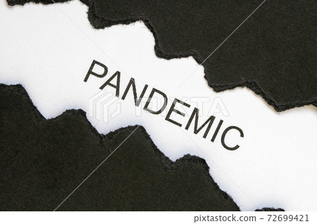 Top view of black torn paper and the word PANDEMIC Top view of black torn paper and the word PANDEMIC 72699421