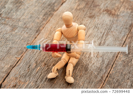 Syringe medical injection in a doll hands Syringe medical injection in a doll hands 72699448