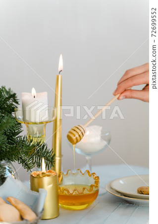 Christmas table with golden candles, honey and pine Christmas table with golden candles, honey and pine 72699552