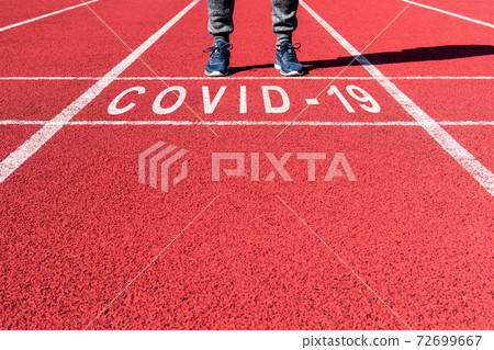 Athlete at the sprint start line in track with Athlete at the sprint start line in track with 72699667