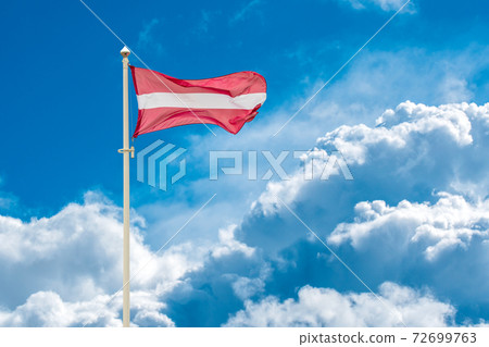 Latvian national flag waving on wind 72699763