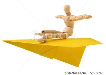 Wooden mannequin flying on a paper plane 72699765