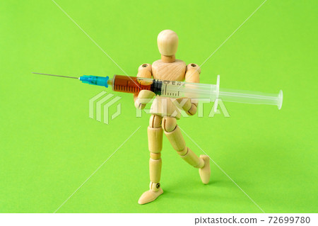 Addict man walk with syringe of heroin 72699780