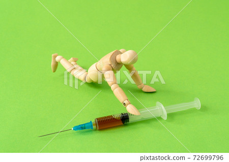 Addict man grab drug syringe of heroin 72699796