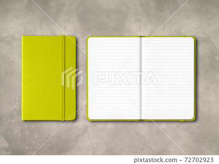 Lime green closed and open lined notebooks on concrete background Lime green closed and open lined notebooks on concrete background 72702923