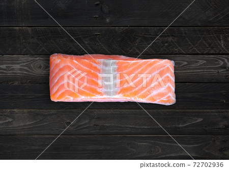 Salmon steak on concrete background 72702936