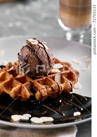 Viennese waffles with ice cream, chocolate and latte. Close-up. On the plate Viennese waffles with ice cream, chocolate and latte. Close-up. On the plate 72703133