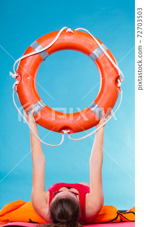 Woman holding life buoy ring 72703503