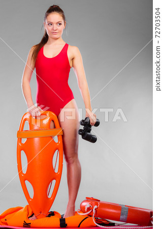 lifeguard on duty holds binocular 72703504
