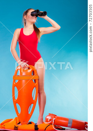 lifeguard on duty looking through binocular 72703505