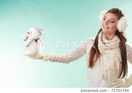 Smiling cute woman with little snowman. Winter. Smiling cute woman with little snowman. Winter. 72703784