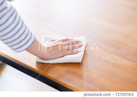 Young woman cleaning 72705563