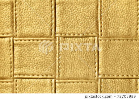 Texture of golden and yellow leather background with square pattern and stitch. 72705989