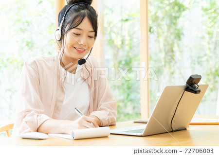 Woman having a web conference at home Woman having a web conference at home 72706003