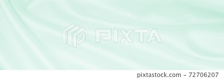 Smooth elegant green silk or satin luxury cloth texture as abstract background. Luxurious background design 72706207