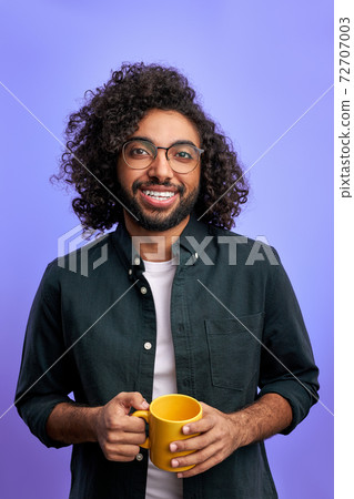 optimistic curly male begins the day with cup of tea optimistic curly male begins the day with cup of tea 72707003
