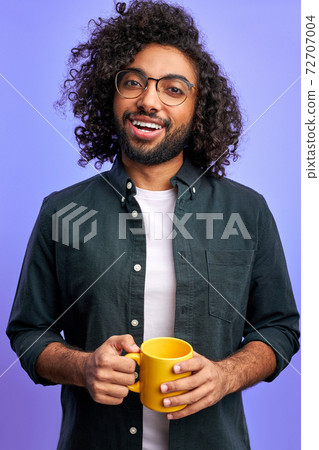 cheerful arabic male begins the day with cup of tea cheerful arabic male begins the day with cup of tea 72707004