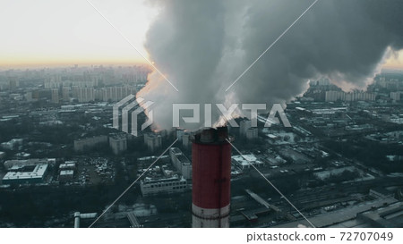 Aerial view of the sun getting obscured by polluting smoke from industrial stack. Moscow, Russia 72707049