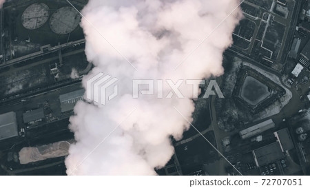 Aerial top-down view of a polluting smoke from a stack in depsessing obsolete industrial area Aerial top-down view of a polluting smoke from a stack in depsessing obsolete industrial area 72707051