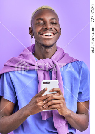 optimistic black male model with device, use smartphone 72707526