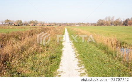 Bike trail in the dutch landscape (Friesland) Bike trail in the dutch landscape (Friesland) 72707742