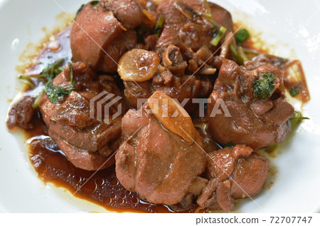 fried chicken in sweet soy sauce with slice garlic on plate fried chicken in sweet soy sauce with slice garlic on plate 72707747